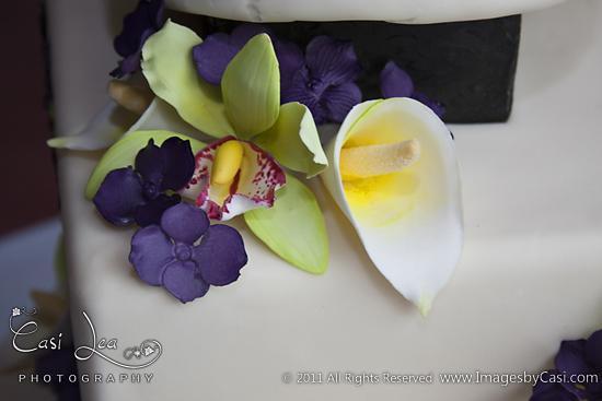A delicate arrangement of green, purple, and white flowers.