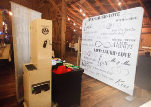 Photo booth with love-themed backdrop.